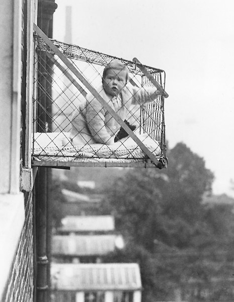 fig.: Baby Cage, 27 January 1934. An example of the wire cage which East Poplar borough council in London propose to fix to the outside of their tenement windows, so that babies can benefit from fresh air and sunshine. (Photo by Fox Photos/Getty Images) Fox Photos.